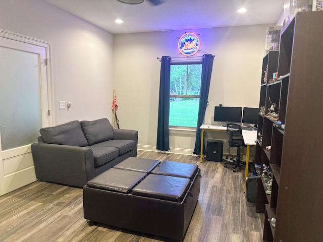living area with recessed lighting and wood finished floors