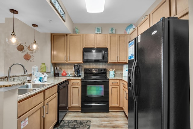 kitchen featuring light wood-type flooring, light brown cabinetry, black appliances, and a sink
