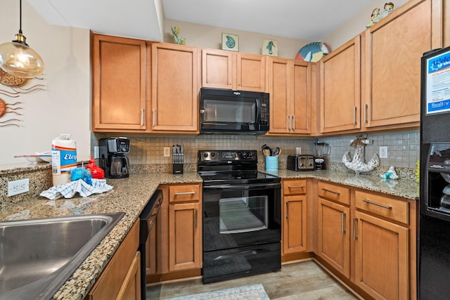 4203 Indian Bayou Trl Unit 1503, Destin, FL 32541 - kitchen featuring black appliances, decorative backsplash, light stone counters, and a sink