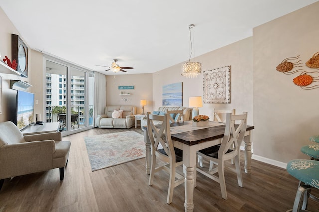 4203 Indian Bayou Trl Unit 1503, Destin, FL 32541 - dining room featuring wood finished floors, floor to ceiling windows, ceiling fan, baseboards, and a chandelier