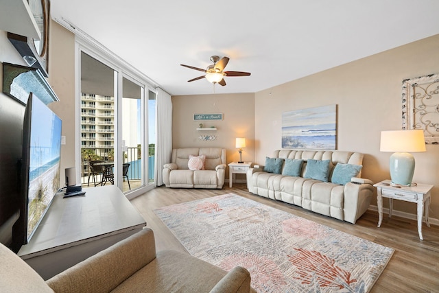 4203 Indian Bayou Trl Unit 1503, Destin, FL 32541 - living room featuring a ceiling fan, wood finished floors, and baseboards
