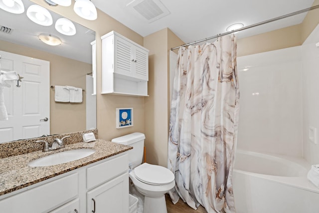 4203 Indian Bayou Trl Unit 1503, Destin, FL 32541 - bathroom featuring vanity, toilet, shower / tub combo with curtain, and wood finished floors