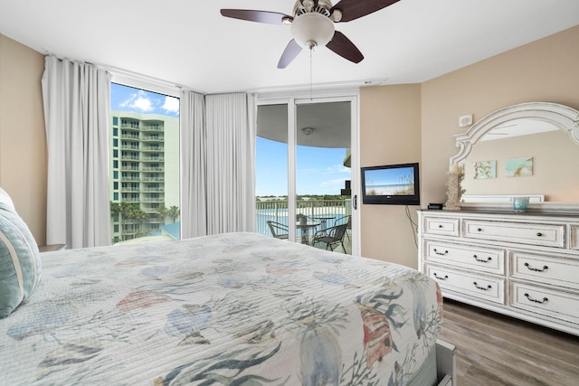 4203 Indian Bayou Trl Unit 1503, Destin, FL 32541 - bedroom featuring access to exterior, multiple windows, wood finished floors, and ceiling fan