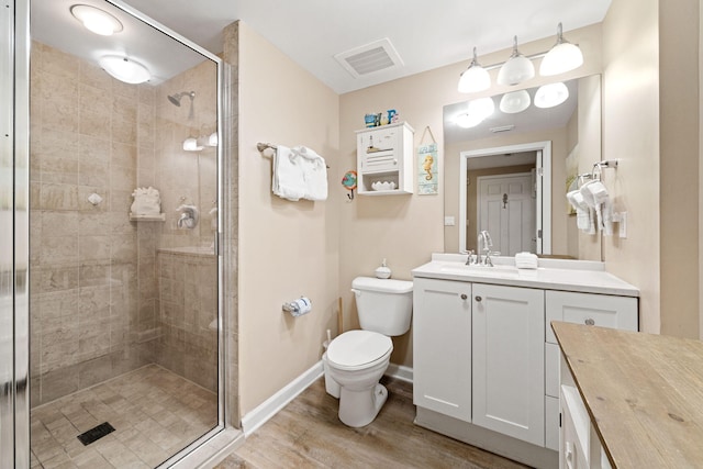 4203 Indian Bayou Trl Unit 1503, Destin, FL 32541 - full bathroom with wood finished floors, a shower stall, toilet, vanity, and baseboards