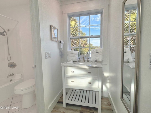 9614 Beach Blvd Unit D, Panama City Beach, FL 32408 - full bathroom featuring vanity, shower / bathtub combination, wood finished floors, toilet, and baseboards