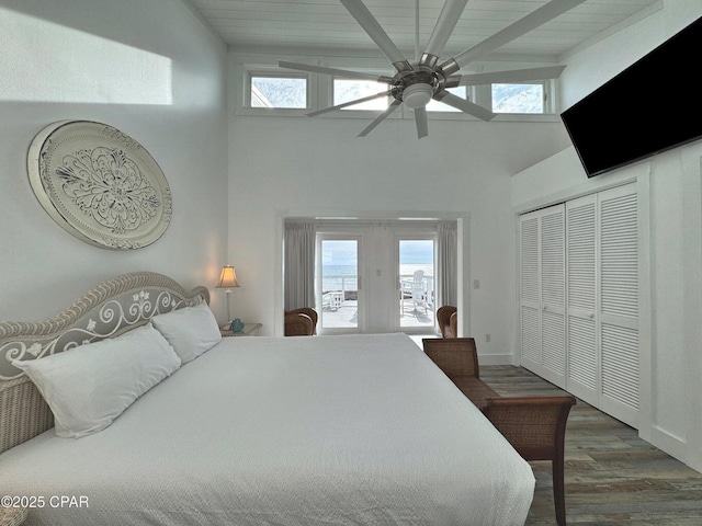 9614 Beach Blvd Unit D, Panama City Beach, FL 32408 - bedroom featuring multiple windows, beamed ceiling, wood finished floors, and a towering ceiling