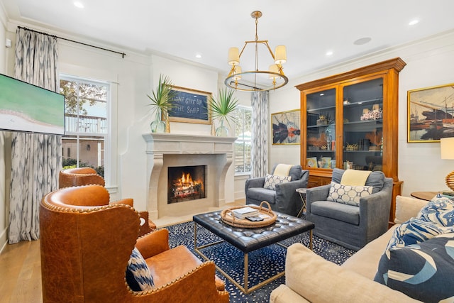 50 Camellia St, Santa Rosa Beach, FL 32459 - living area with a chandelier, wood finished floors, crown molding, a warm lit fireplace, and recessed lighting