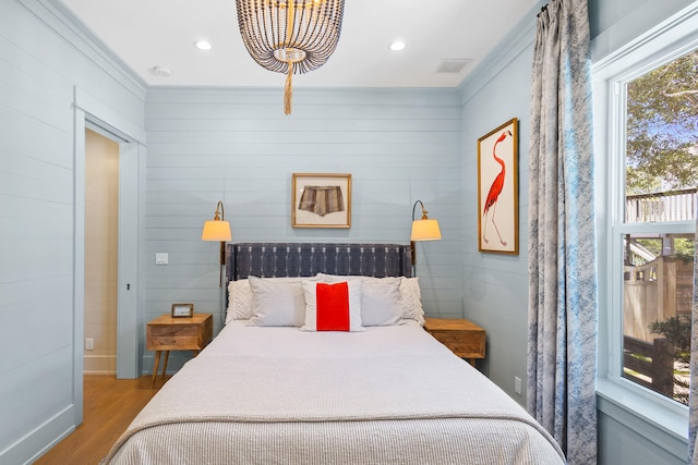 50 Camellia St, Santa Rosa Beach, FL 32459 - bedroom featuring wood finished floors, a chandelier, ornamental molding, recessed lighting, and baseboards