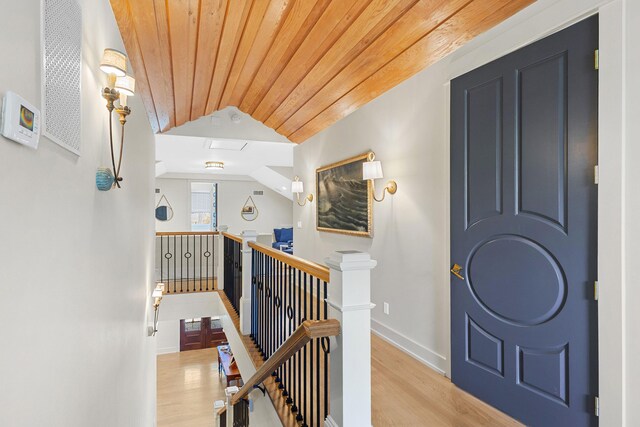 50 Camellia St, Santa Rosa Beach, FL 32459 - hall featuring an upstairs landing, vaulted ceiling, wood ceiling, wood finished floors, and baseboards