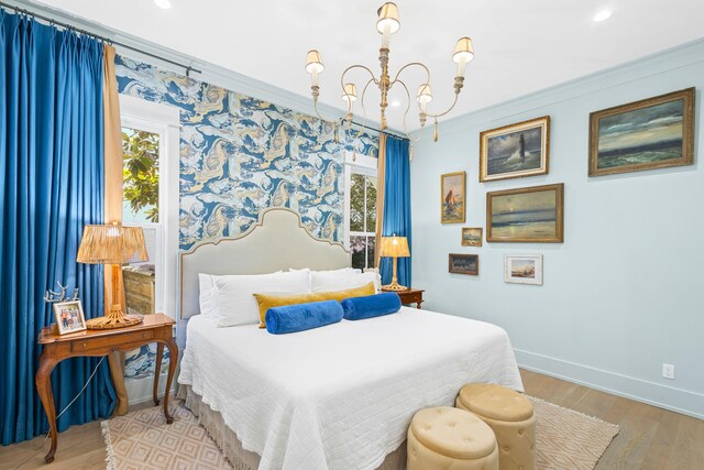 50 Camellia St, Santa Rosa Beach, FL 32459 - bedroom with a chandelier, ornamental molding, baseboards, multiple windows, and wood finished floors