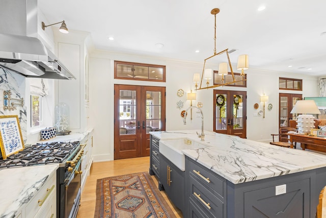 50 Camellia St, Santa Rosa Beach, FL 32459 - kitchen featuring french doors, range hood, a sink, range with two ovens, and crown molding