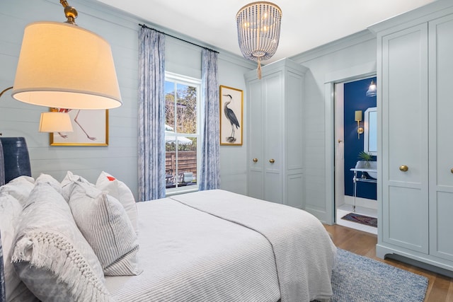 50 Camellia St, Santa Rosa Beach, FL 32459 - bedroom featuring dark wood finished floors, a chandelier, and ornamental molding