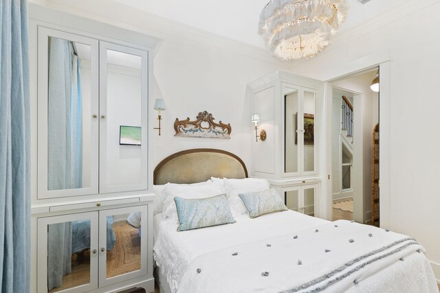 50 Camellia St, Santa Rosa Beach, FL 32459 - bedroom featuring a chandelier, french doors, and crown molding