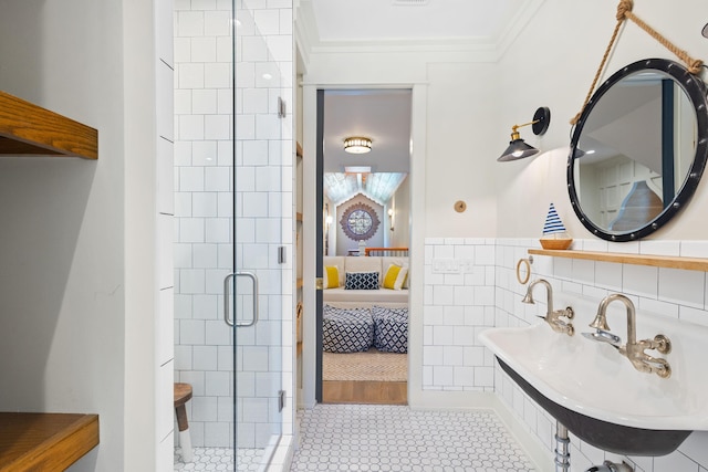 50 Camellia St, Santa Rosa Beach, FL 32459 - ensuite bathroom with crown molding, a shower stall, tile walls, tile patterned floors, and a sink