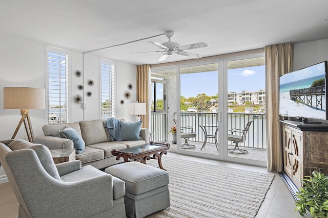 living room with a ceiling fan and light tile patterned flooring