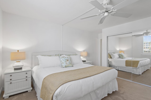 carpeted bedroom featuring a ceiling fan and a closet