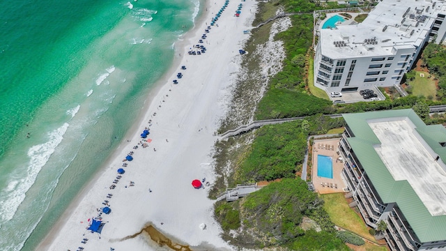 aerial view of waterfront with a beach and a pool