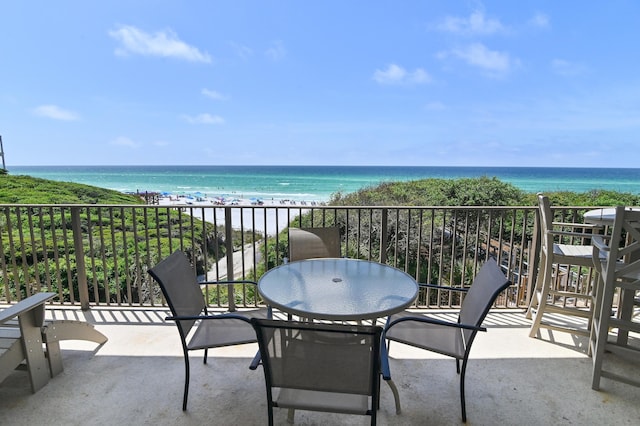balcony featuring view of water and beach