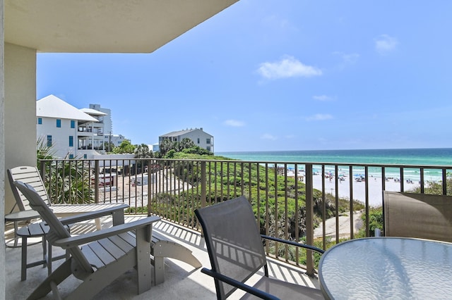 balcony with view of water and beach