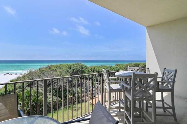 balcony with view of water and beach