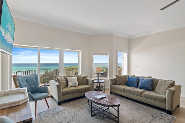 living area featuring crown molding and a water view