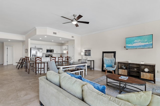 living area featuring ornamental molding, a ceiling fan, baseboards, and recessed lighting