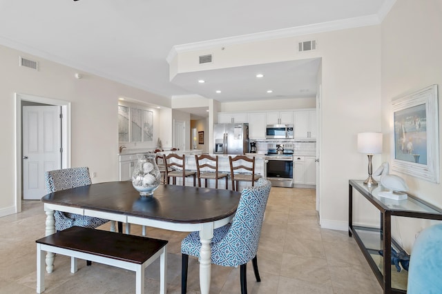 dining room with ornamental molding, baseboards, light tile patterned floors, and recessed lighting