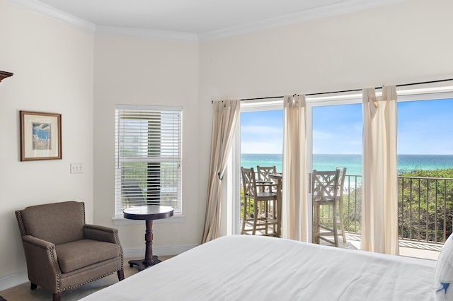 bedroom featuring access to exterior, a water view, baseboards, crown molding, and multiple windows