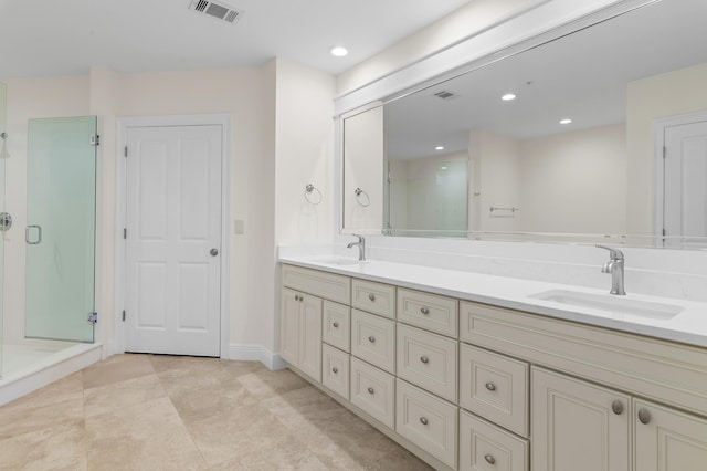 full bathroom featuring a stall shower, double vanity, recessed lighting, and baseboards