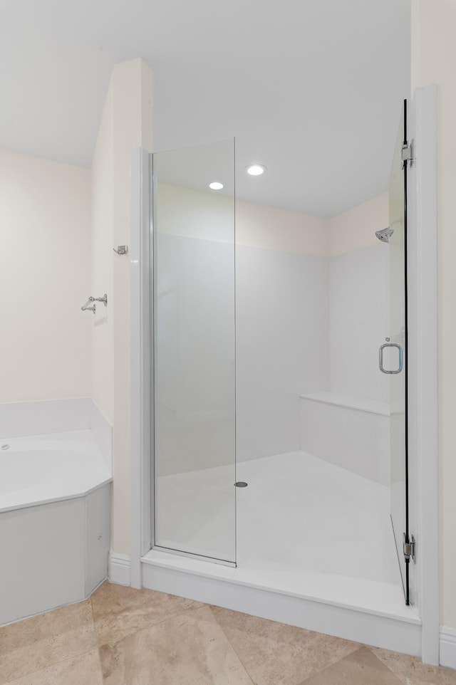 full bath featuring a stall shower, a bath, and recessed lighting