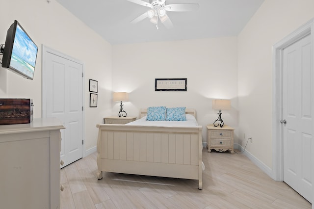 bedroom with baseboards, light wood-style flooring, and ceiling fan