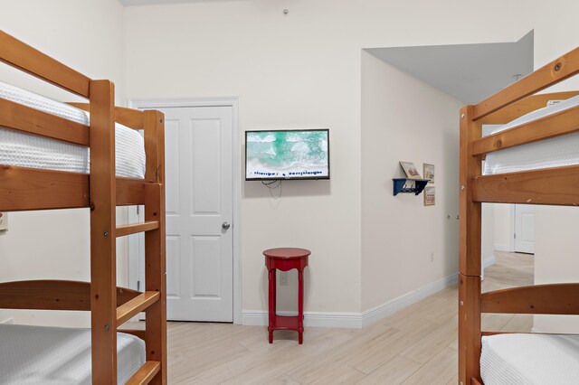 bedroom featuring wood finished floors and baseboards