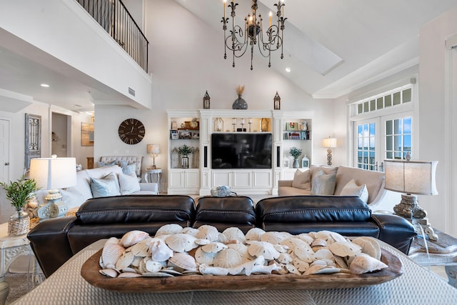 living room with a chandelier and high vaulted ceiling