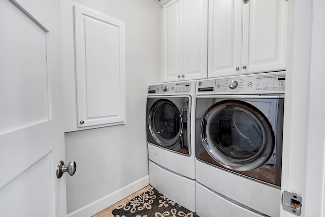 washroom with cabinet space, separate washer and dryer, baseboards, and tile patterned flooring