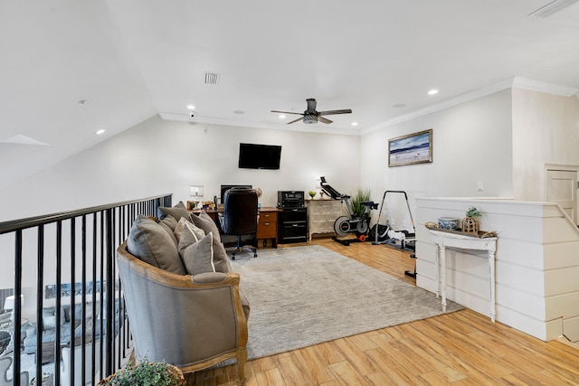 office space with crown molding, a ceiling fan, wood finished floors, and visible vents
