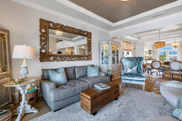 living room featuring visible vents, crown molding, wood finished floors, wooden ceiling, and a raised ceiling