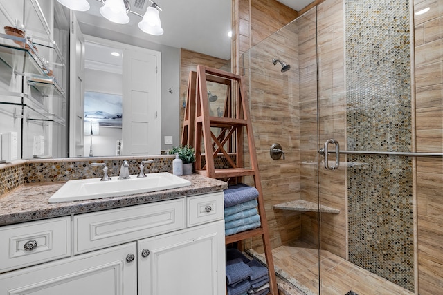 full bath with vanity and a shower stall