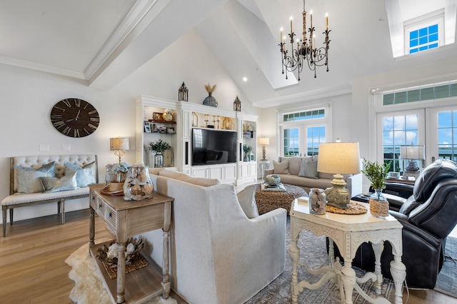 living room featuring high vaulted ceiling, a chandelier, plenty of natural light, and light wood-type flooring
