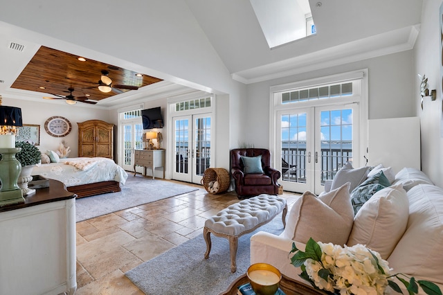 bedroom with a high ceiling, french doors, stone tile flooring, and access to exterior