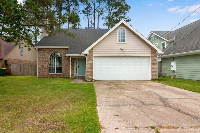 view of front facade with driveway, brick siding, fence, a front lawn, and an attached garage