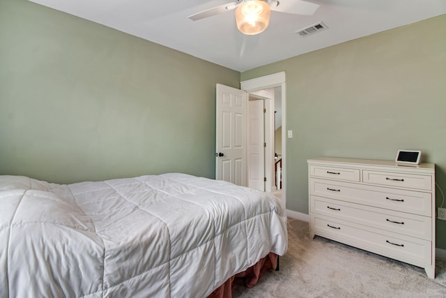 bedroom featuring baseboards, light carpet, a ceiling fan, and visible vents