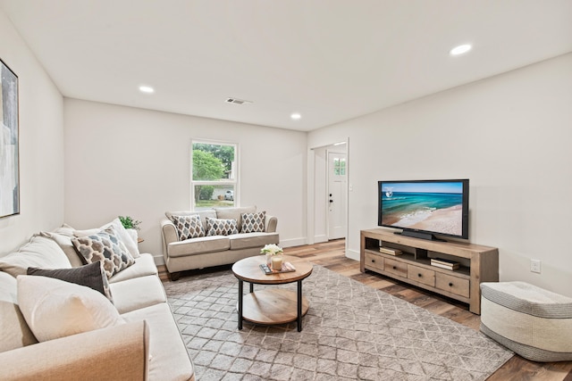 living area featuring visible vents, recessed lighting, and wood finished floors