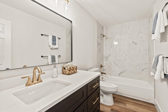 bathroom featuring toilet, shower / bath combination, wood finished floors, and vanity