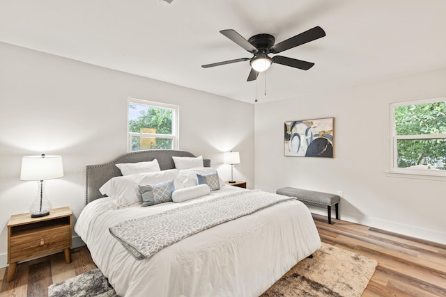 bedroom featuring baseboards, ceiling fan, and wood finished floors
