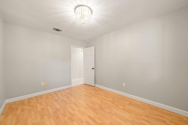 1501 Royal Palm Dr, Niceville, FL 32578 - unfurnished room with light wood-style floors, baseboards, and a chandelier