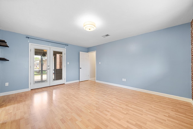 1501 Royal Palm Dr, Niceville, FL 32578 - unfurnished room featuring light wood finished floors, baseboards, and french doors