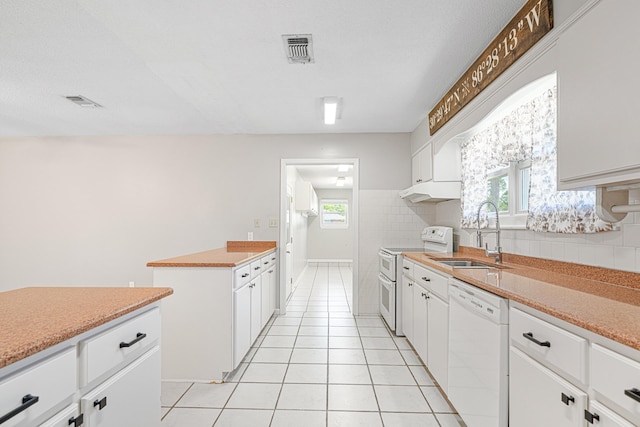 1501 Royal Palm Dr, Niceville, FL 32578 - kitchen with white appliances, a sink, tasteful backsplash, and white cabinets