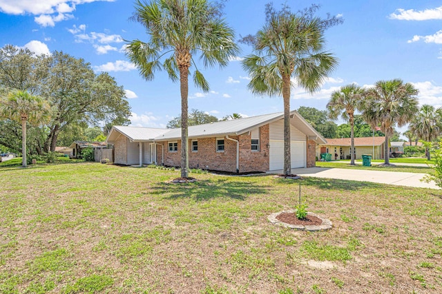 1501 Royal Palm Dr, Niceville, FL 32578 - view of property exterior with concrete driveway, a garage, a lawn, and brick siding