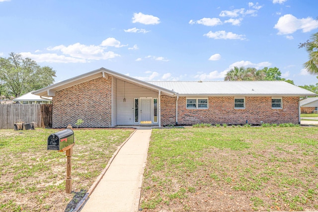 1501 Royal Palm Dr, Niceville, FL 32578 - view of front facade featuring brick siding and metal roof