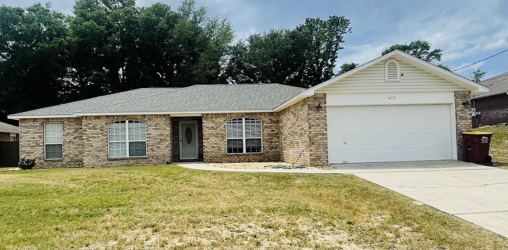 437 Hatchee Dr, Crestview, FL 32536 - ranch-style home featuring an attached garage, a front yard, driveway, brick siding, and roof with shingles
